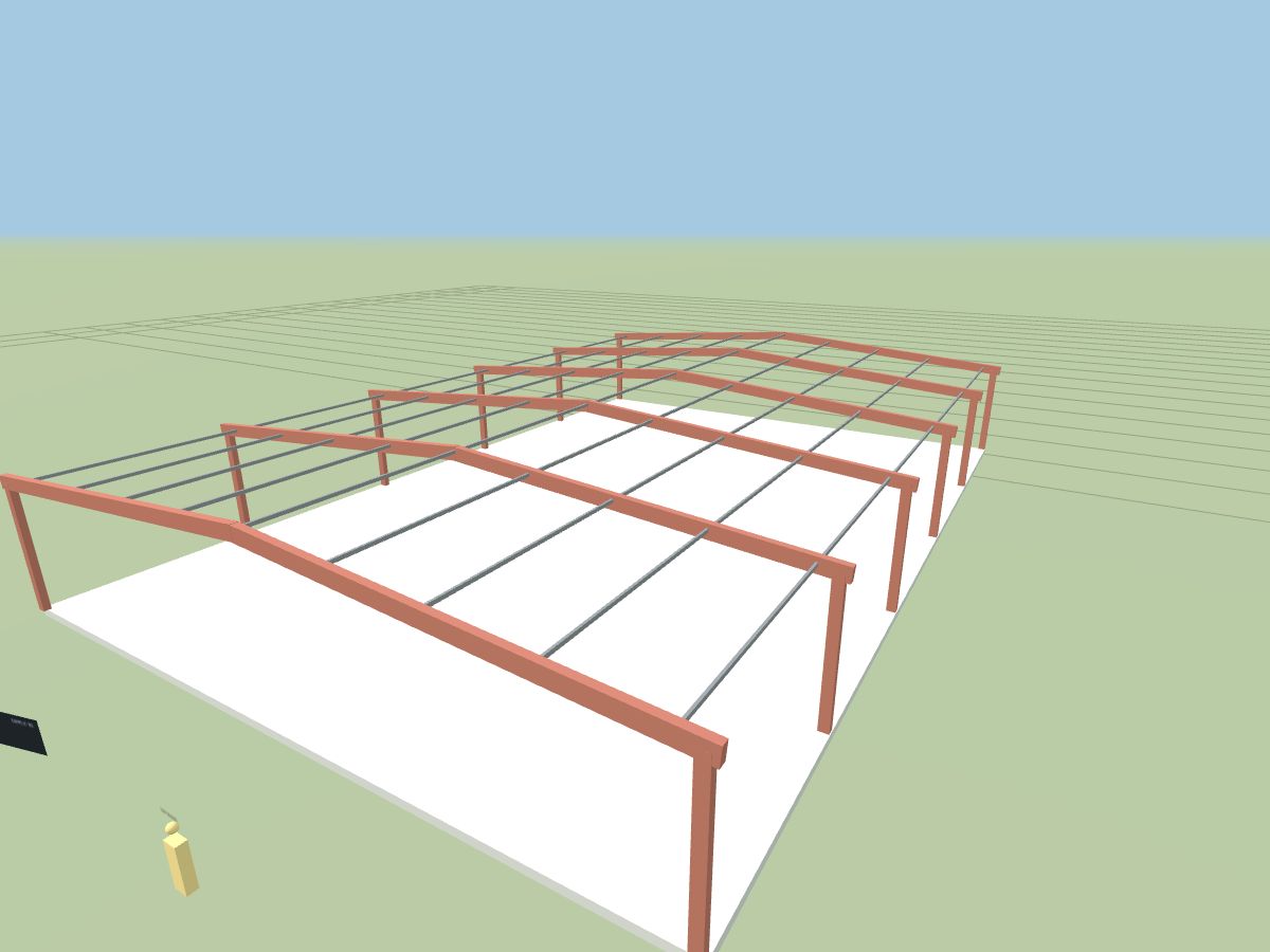 A metal building frame shown at full scale on its slab in the VR room, with a six-foot figure for scale
